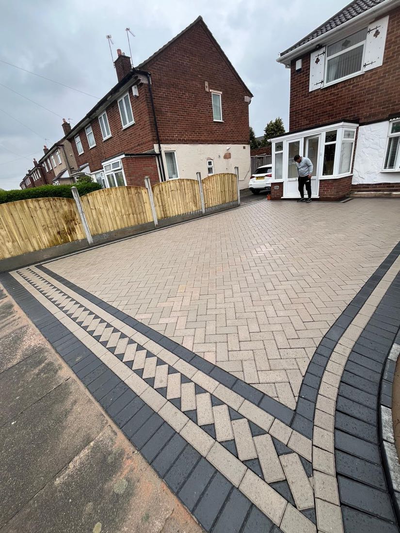 Buff herringbone block paving with twin charcoal border and new close-board fencing