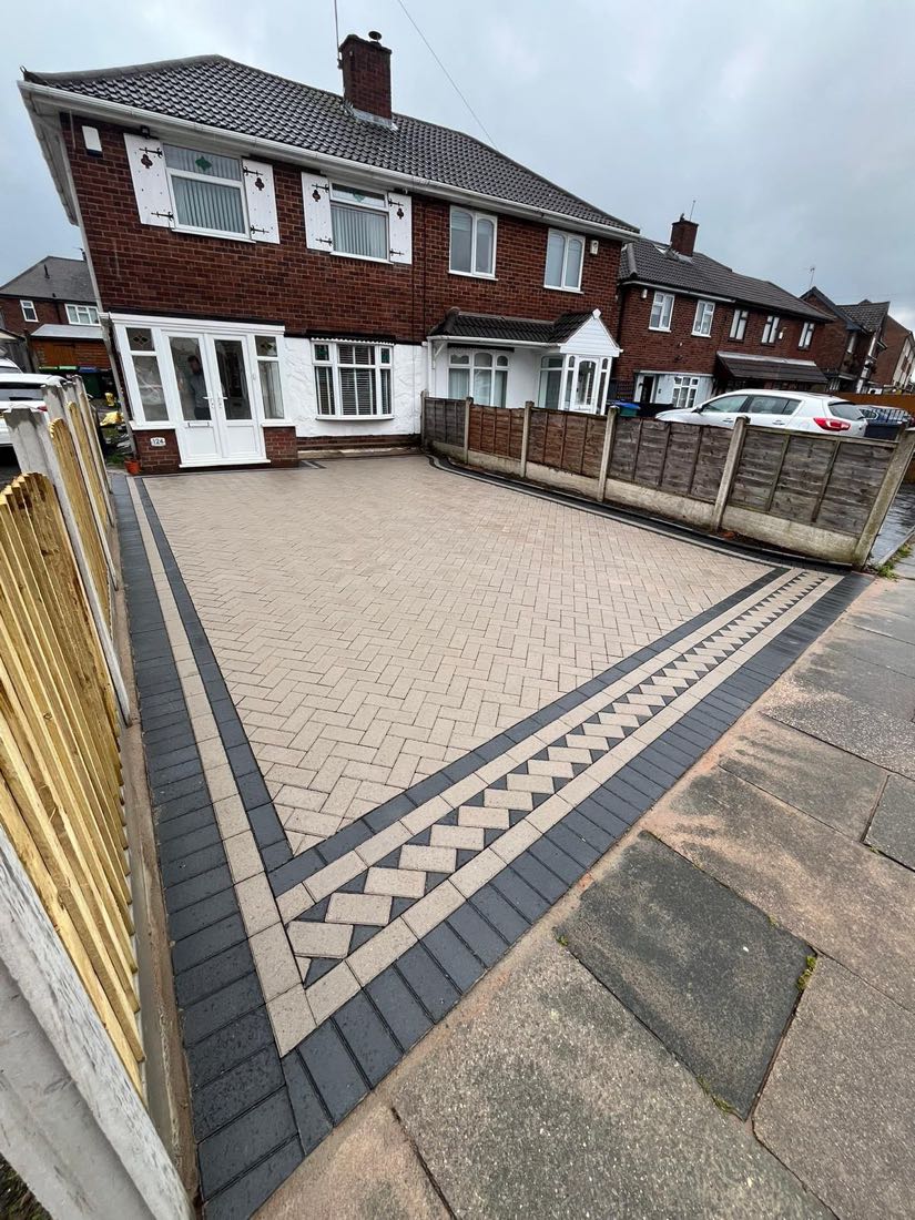 Buff herringbone block paving driveway with charcoal and cream decorative border, West Midlands