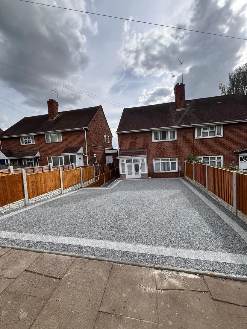 Grey resin bound driveway with a contrasting border, laid across a full frontage