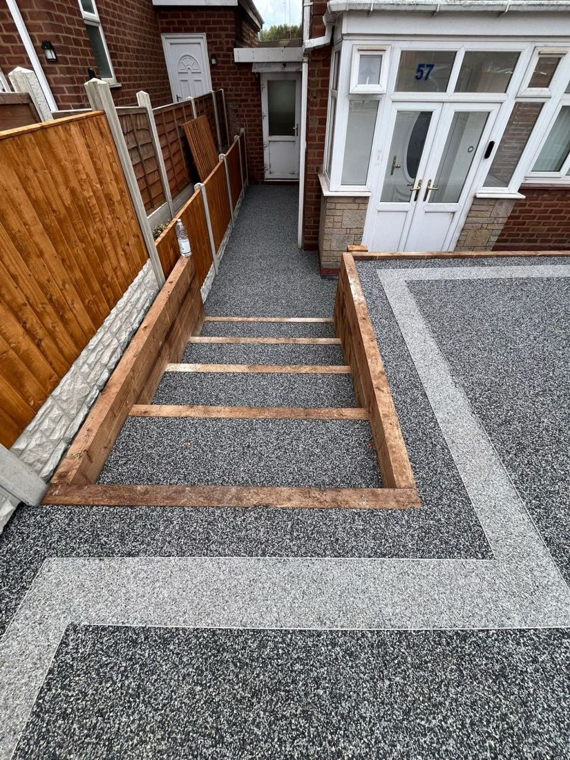 Resin bound driveway with timber-edged borders and a matching entrance run